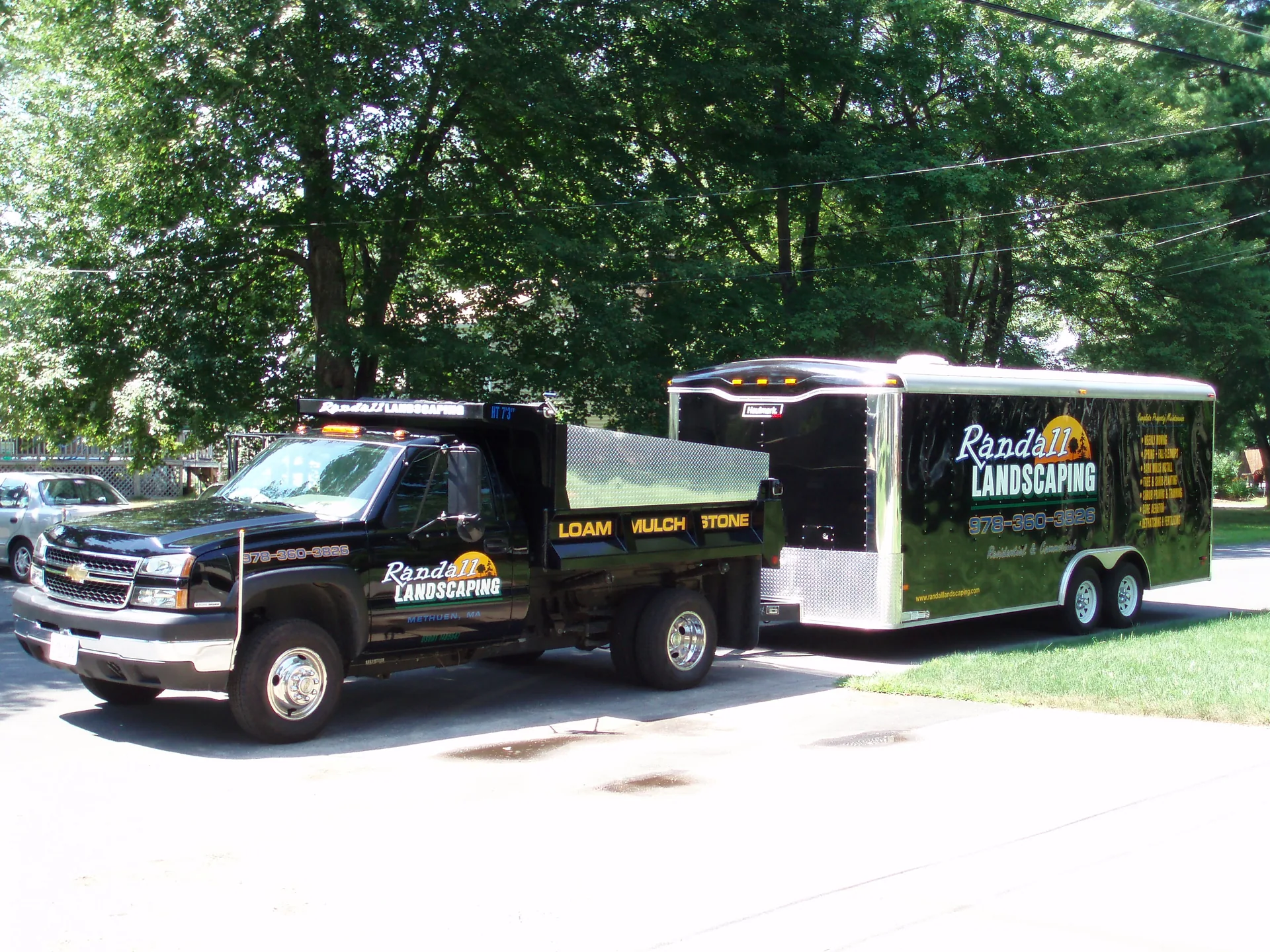 Randall Landscaping dump truck and enclosed equipment trailer in Methuen, Massachusetts